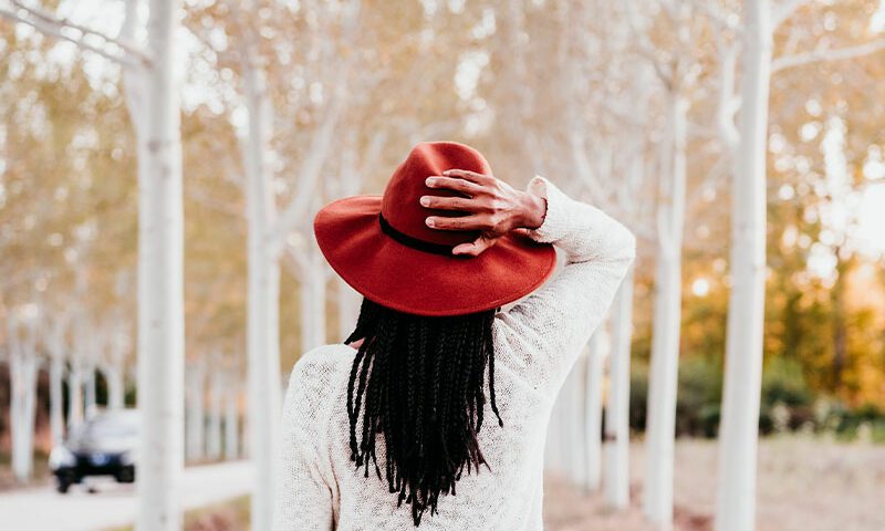 Woman with hair flowing walking in fall