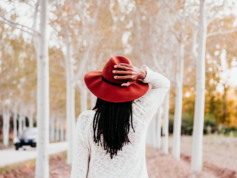 Woman with hair flowing walking in fall